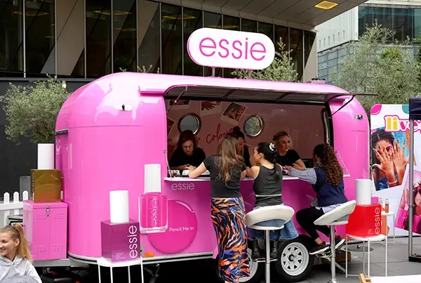 pink essie trailer with people providing pedicures to passers by